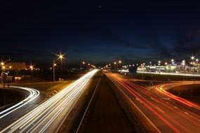 Night traffic on highway, bright lights in darkness