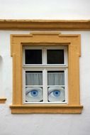 decoration of eyes looking from window