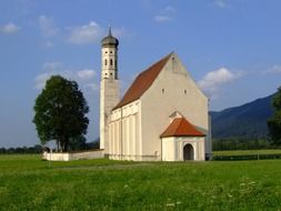 St. Coloman’s sanctuary on meadow near mountains, Germany, Allgaeu