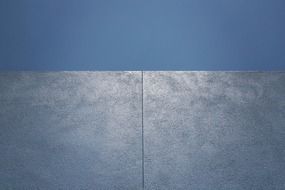 grey stucco wall at blue sky