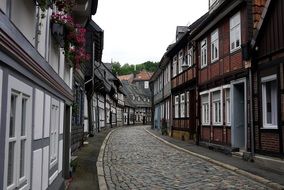 picturesque street with truss houses and cobblestone pavement, germany, goslar