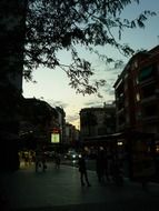 pedestrians in city at summer evening