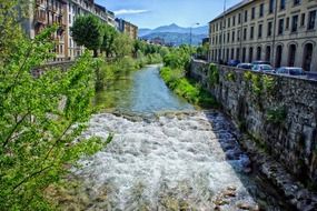 landscape of foamy waterflow in old city, france, chambery