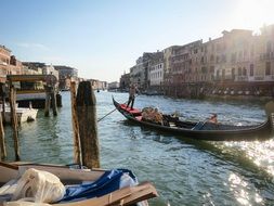 cityscape with people in gondola on canal, italy, venice