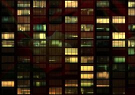 light in windows of office building at night