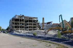 excavator among the ruins at a construction site