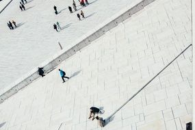 people walking pedestrians stones shadows