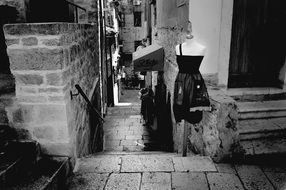 fashion clothing on stands in alley of old city