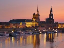 dusk skyline with tourist boats on water at cathedral, germany, dresden