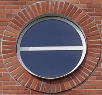 round window in red brick wall