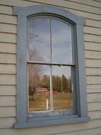 window with reflection on wooden wall