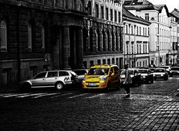 yellow taxi at crosswalk in old city