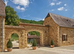 stone wall with gateways, entrance to park, france, dordogne