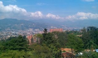 scenery landscape with city on green mountains under clouds, colombia, medellín