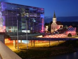 colorful illuminated modern buildings at night, austria, linz