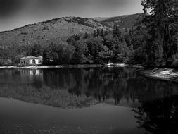 building on shoreline at mountain, spain, segovia