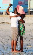 young dark skin couple in love taking photo on beach, south africa, cape town