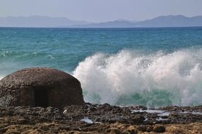 beautiful seascape with foamy surf waves splashing on beach, spain, mallorca