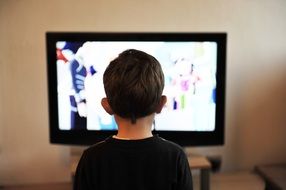 child boy watching tv at home