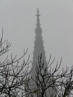 spire of ulm cathedral at foggy winter sky, germany, munich