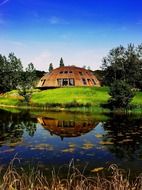 scenic countryside landscape, domed house at pond, russia