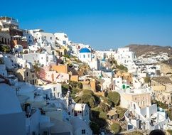 beautiful old buildings on mountain side at sea, greece, santorini, oia