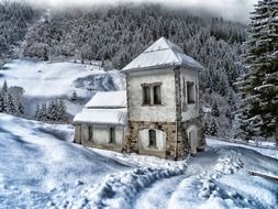 scenic winter landscape, old stone building at snowy forest, austria