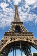 art metal structure of the Eiffel Tower on the background of clouds