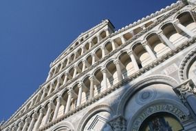 diagonal low angle view of cathedral facade at sky, italy, pisa