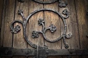 gothic wrought iron floral ornament on wooden door