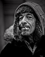 middle aged man in winter clothing with cigarette in lips, portrait