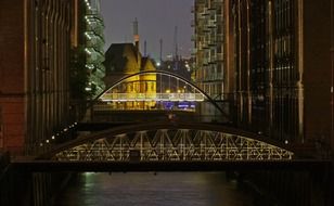 illuminated bridges above water at night, germany, hamburg, speicherstadt