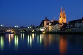 beautiful night cityscape with bridge, old town and cathedral, germany, regensburg