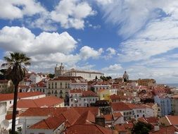 red roofs of old city under blue sky with white clouds, portugal, lisbon