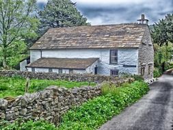 old stone village building at road, uk, england, sedbergh