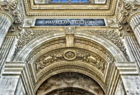 ornate entrance to louvre palace, france, paris