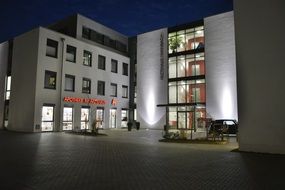contemporary lightened building at evening, germany, rheinbach