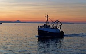 fishing boat at the sunset in harbor