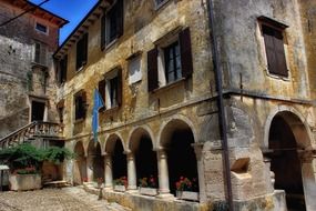 old city building with external staircase and arched passage, croatia, groznjan