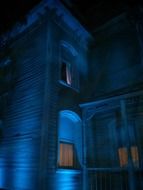 old house with illuminated windows at night