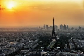 orange sunset sky above grey cityscape, france, paris