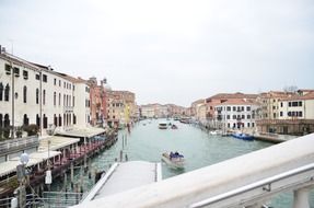 old embankment and boats on channel, italy, venice
