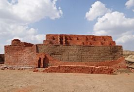 large pile of red and brown bricks on ground, india, dharwad