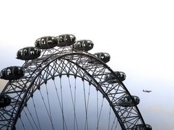 london eye and the plane on a ground of sky