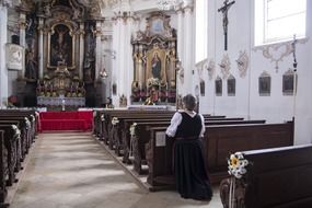 praying woman in baroque church, germany, berbling