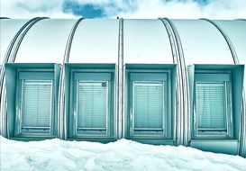 modern building with closed windows on snow