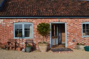 old red brick house with open front door