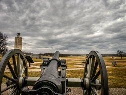 oldtime cannon on battlefield under clouds, usa, pennsylvania, gettysburg