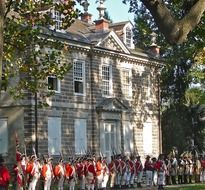 soldiers in oldtime uniform at historical building, reenactment, usa, pennsylvania, germantown