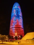 torre agbar, colorful illuminated scyscraper in night city, spain, barcelona